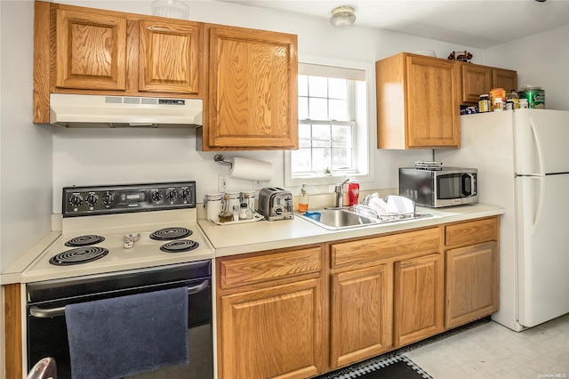 kitchen with electric range, sink, and white fridge