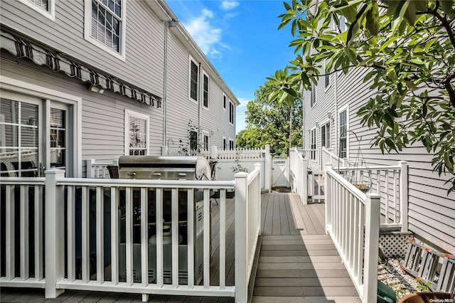 wooden terrace featuring grilling area