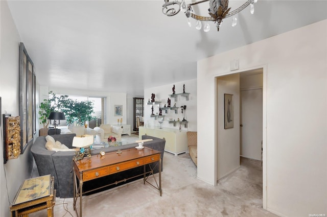 carpeted living room with an inviting chandelier