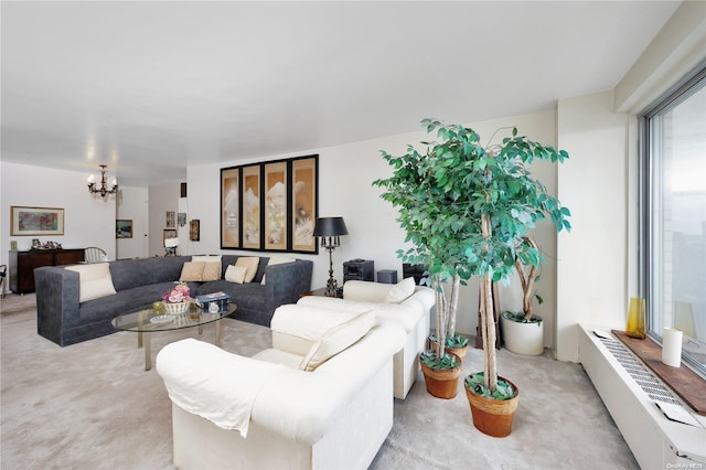 carpeted living room with an inviting chandelier