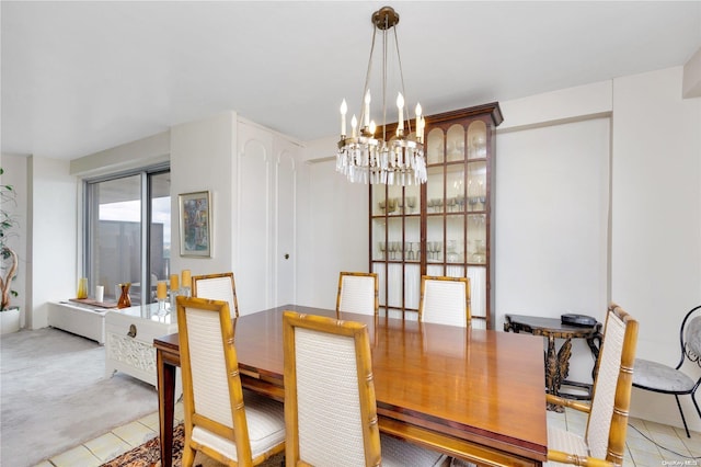 carpeted dining room featuring a chandelier