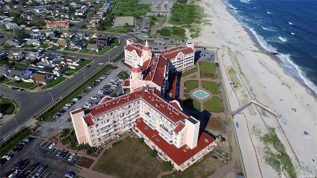 birds eye view of property featuring a beach view and a water view