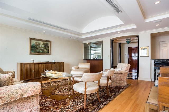 living room featuring light wood-type flooring and ornamental molding