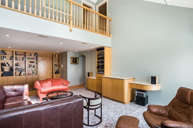 living room with light carpet and a high ceiling