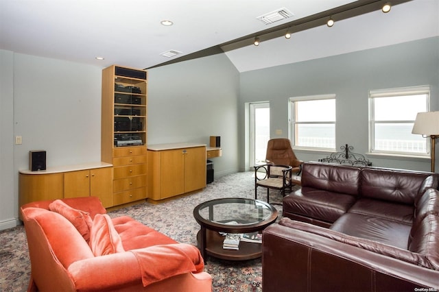 carpeted living room with track lighting