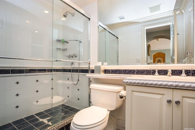 bathroom featuring walk in shower, ornamental molding, vanity, tile walls, and toilet