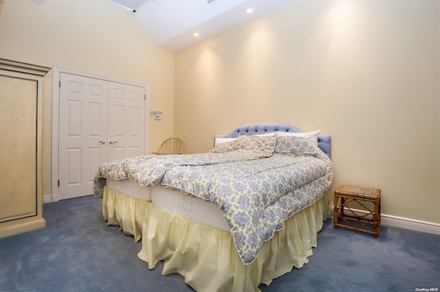 carpeted bedroom featuring a closet and high vaulted ceiling