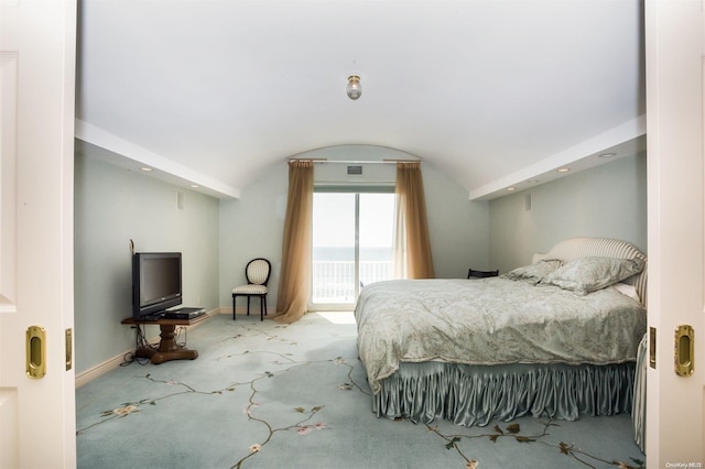 bedroom with carpet floors and vaulted ceiling