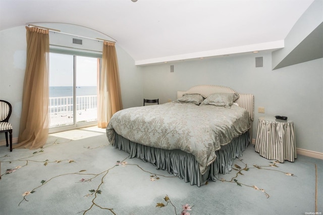 carpeted bedroom with access to outside and a water view