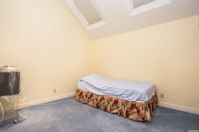 carpeted bedroom featuring vaulted ceiling with skylight