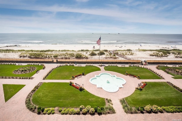 view of home's community with a water view and a beach view