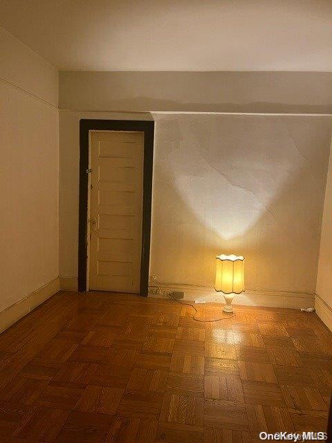 unfurnished room featuring parquet flooring