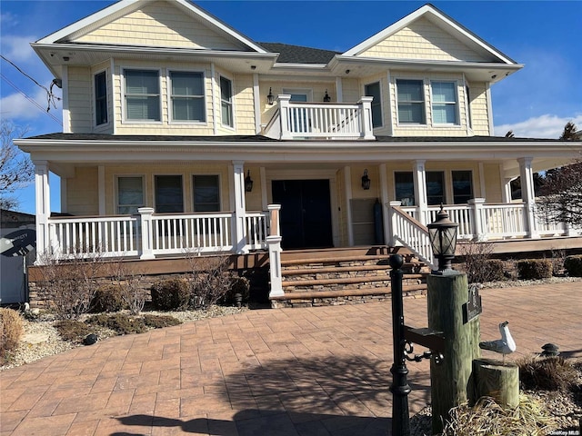 view of front of home featuring a porch and a balcony