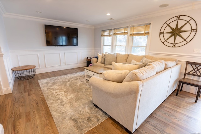 living room with crown molding and hardwood / wood-style floors