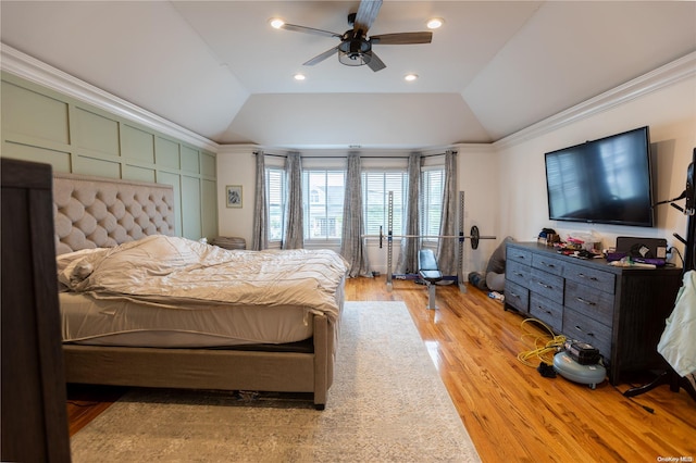 bedroom featuring ceiling fan, light hardwood / wood-style floors, lofted ceiling, and crown molding