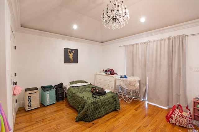 bedroom featuring lofted ceiling, ornamental molding, a notable chandelier, and hardwood / wood-style flooring