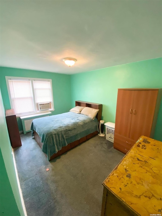 bedroom featuring dark colored carpet and cooling unit