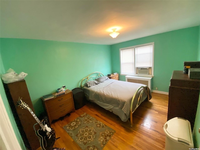 bedroom featuring cooling unit and wood-type flooring