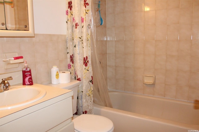 full bathroom with shower / tub combo with curtain, vanity, tile walls, and toilet