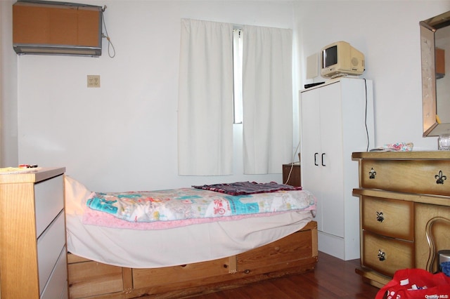 bedroom with dark wood-type flooring