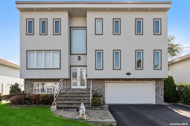 view of front of house featuring a garage and french doors