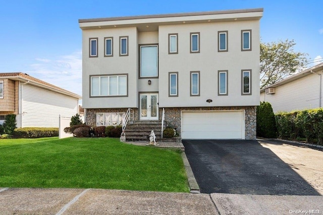 view of front facade with a front yard, french doors, and a garage