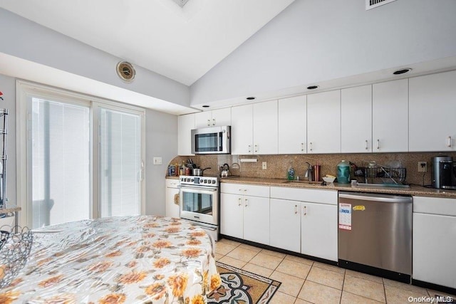 kitchen with white cabinets, high vaulted ceiling, and appliances with stainless steel finishes