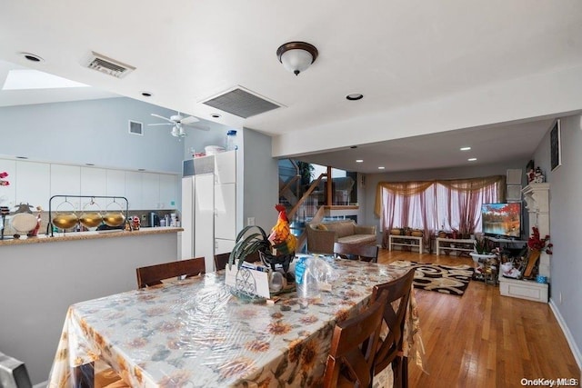 dining space featuring wood-type flooring and ceiling fan