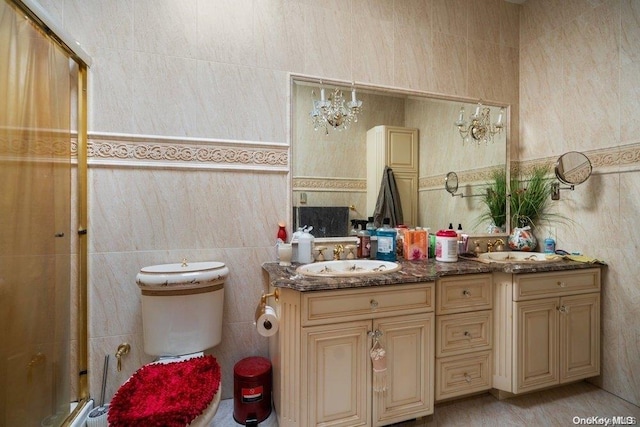 bathroom with vanity, a chandelier, tile walls, and toilet