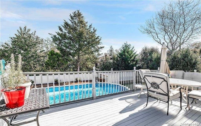 deck featuring a fenced in pool