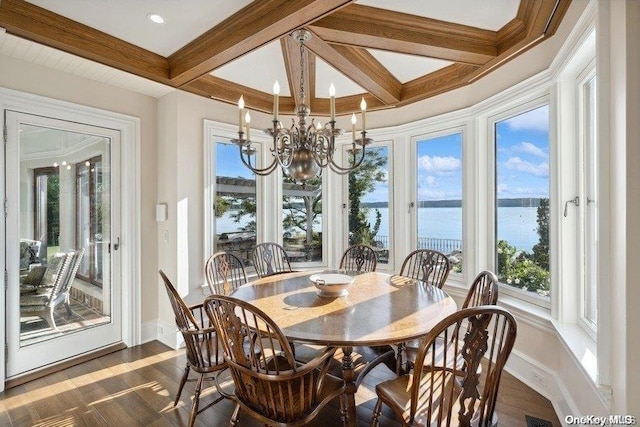 dining room featuring plenty of natural light, a water view, and beamed ceiling