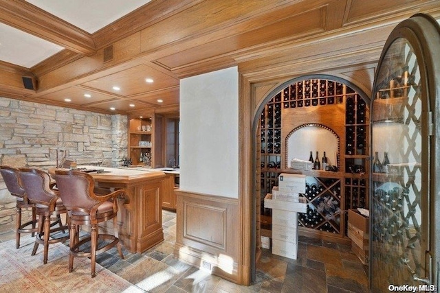 wine cellar featuring bar area and beam ceiling