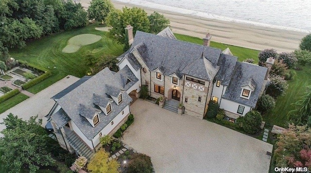 birds eye view of property with a beach view and a water view