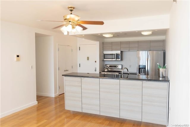 kitchen with ceiling fan, light hardwood / wood-style flooring, sink, and appliances with stainless steel finishes