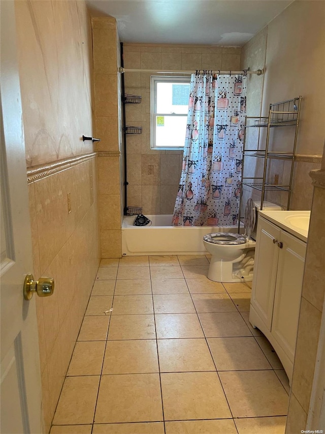 full bathroom featuring vanity, shower / bathtub combination with curtain, toilet, and tile walls