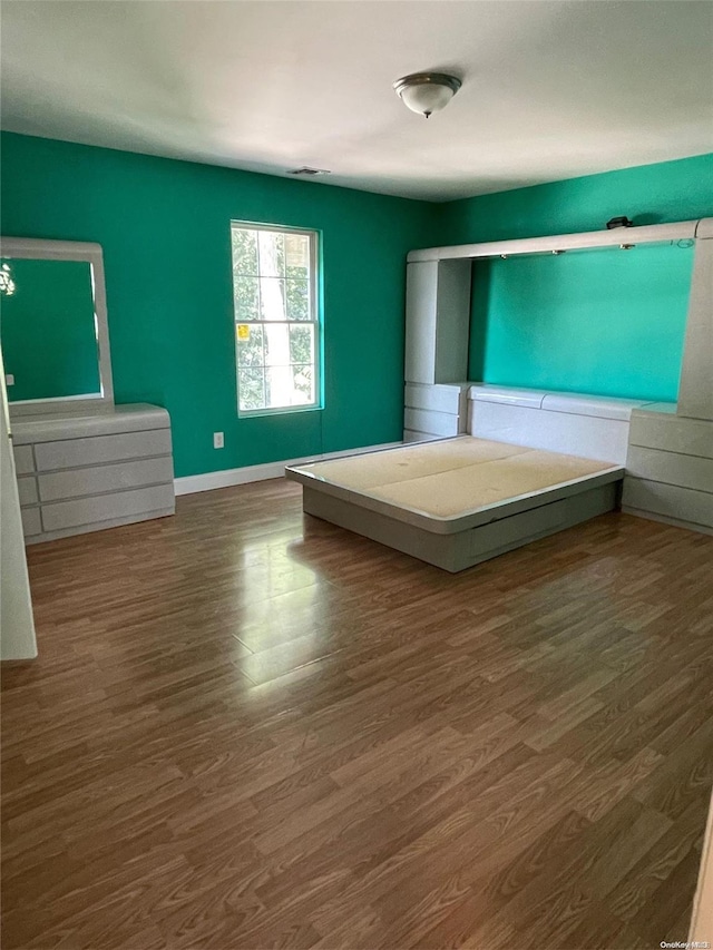 unfurnished bedroom featuring dark hardwood / wood-style flooring