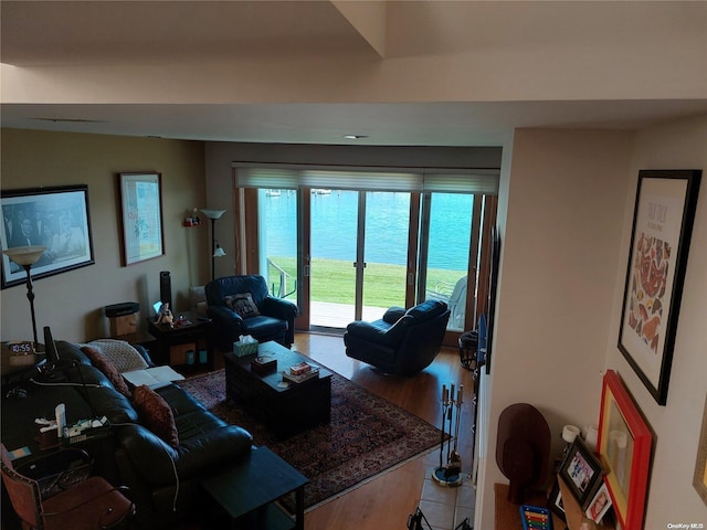 living room with a water view and hardwood / wood-style flooring