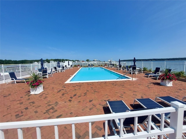 view of pool with a water view