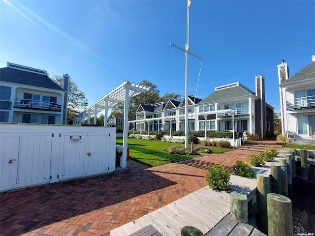 exterior space with a lawn and a pergola