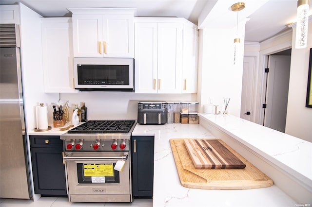 kitchen featuring white cabinets, decorative light fixtures, stainless steel appliances, and light stone counters