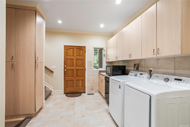 laundry room featuring separate washer and dryer, crown molding, and cabinets