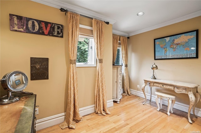 miscellaneous room with ornamental molding, a baseboard radiator, and light hardwood / wood-style flooring