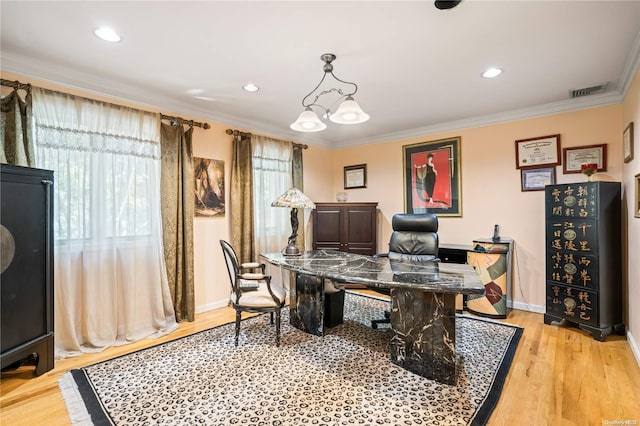 home office with a chandelier, light hardwood / wood-style floors, and crown molding