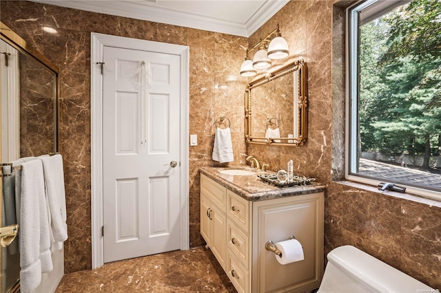 bathroom with vanity, toilet, tile walls, and ornamental molding