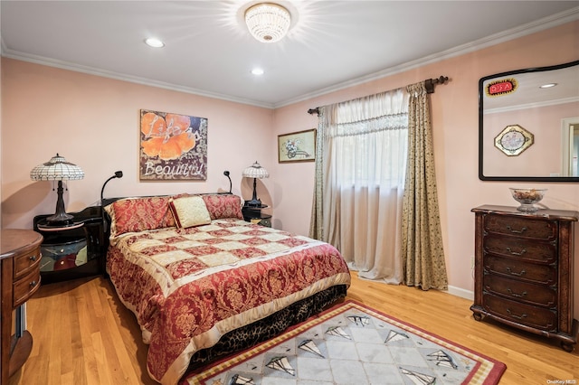 bedroom with light hardwood / wood-style floors and crown molding