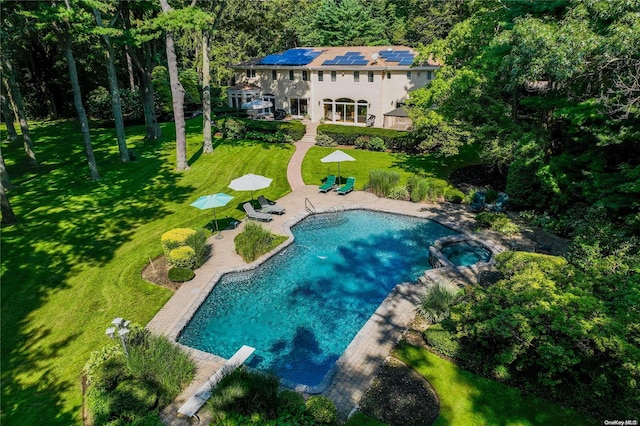 view of swimming pool featuring an in ground hot tub, a patio, a diving board, and a lawn