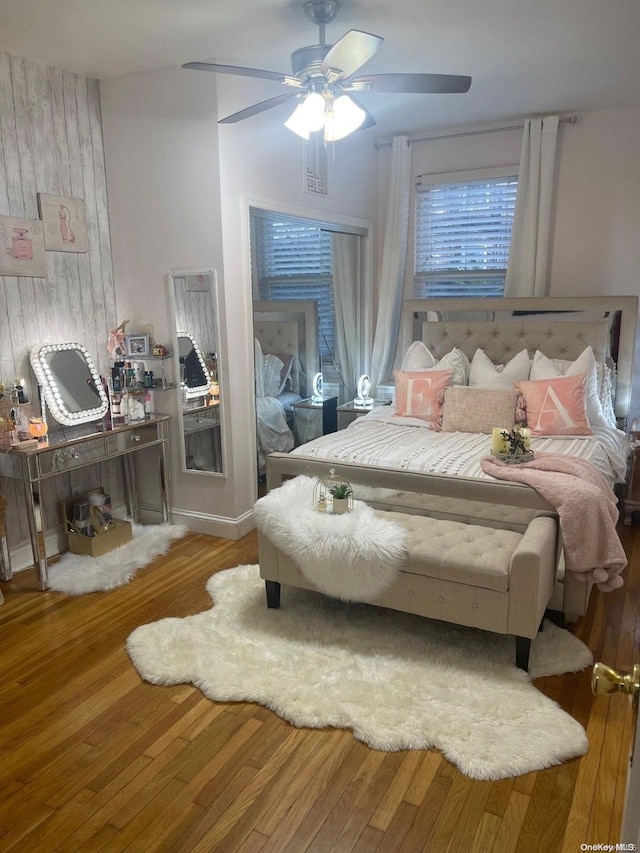 bedroom with ceiling fan and wood-type flooring