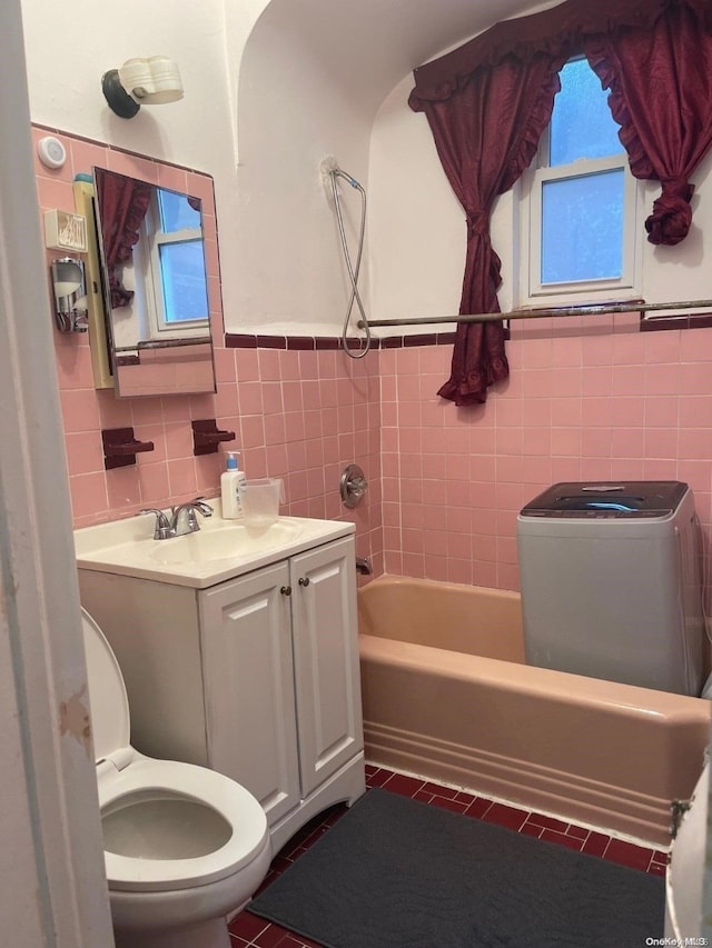 bathroom with tile patterned flooring, vanity, tile walls, and toilet