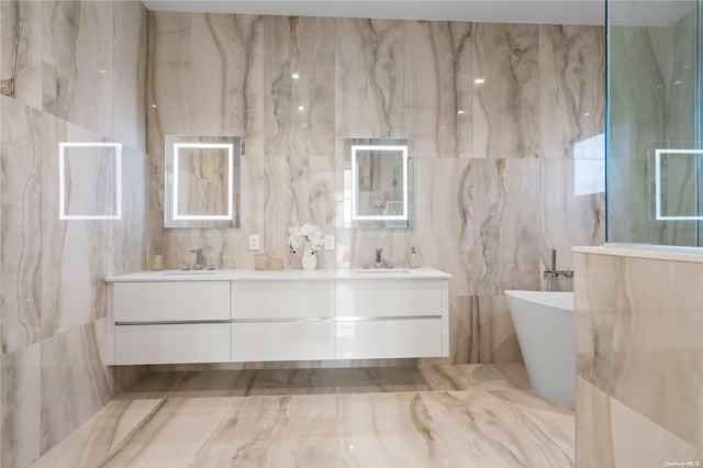 bathroom with vanity, tile walls, and a washtub