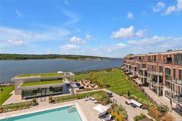 view of pool with a water view and a patio area